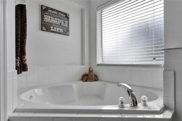 bathroom with a relaxing tiled tub