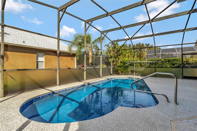 view of swimming pool with a lanai and a patio