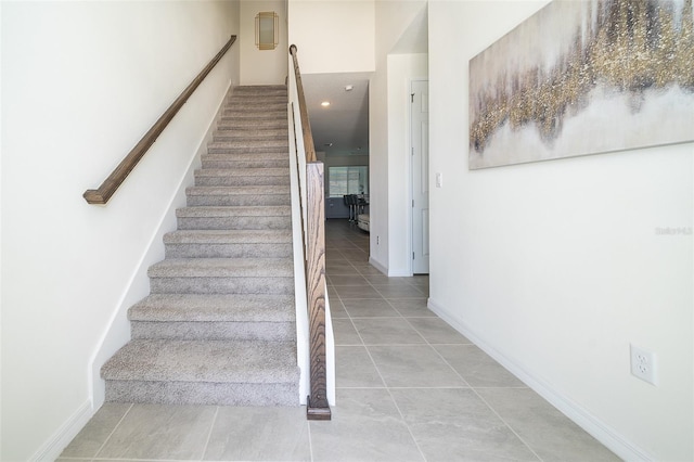 stairway with tile patterned flooring