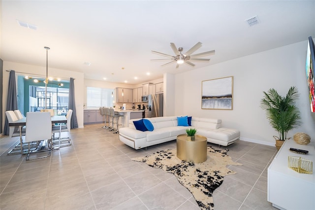 tiled living room with ceiling fan