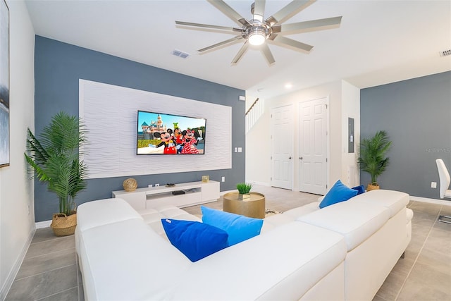 home theater with light tile patterned floors and ceiling fan