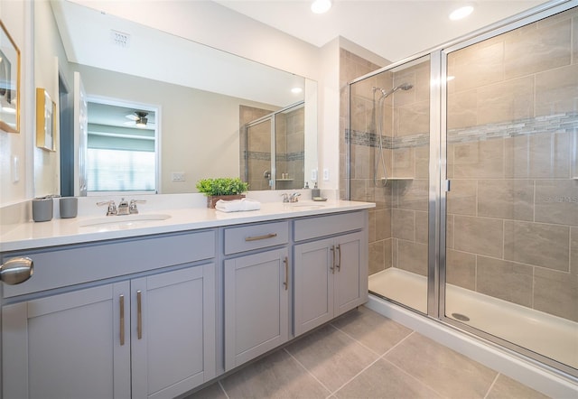 bathroom with walk in shower, vanity, tile patterned flooring, and ceiling fan