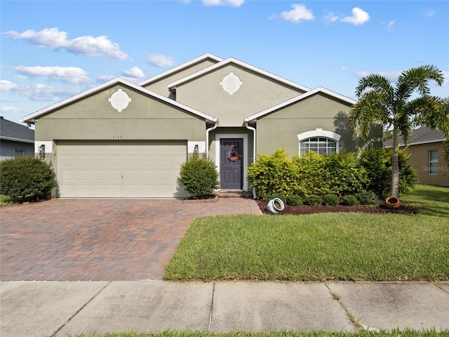 view of front of house with a garage and a front yard