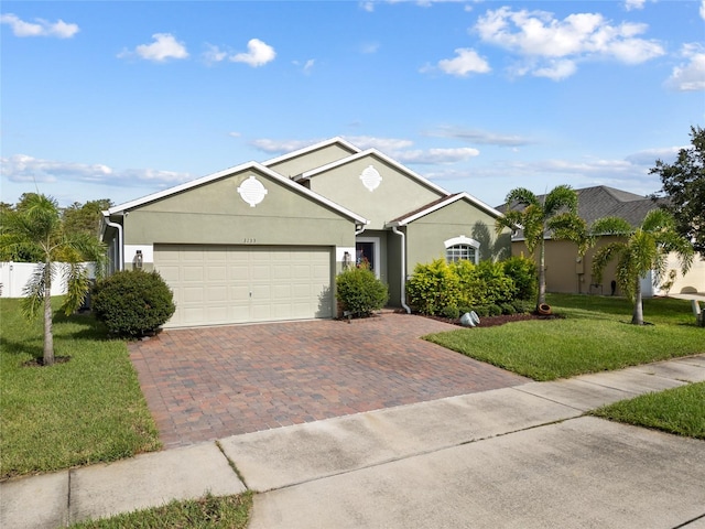 ranch-style house featuring a garage and a front yard