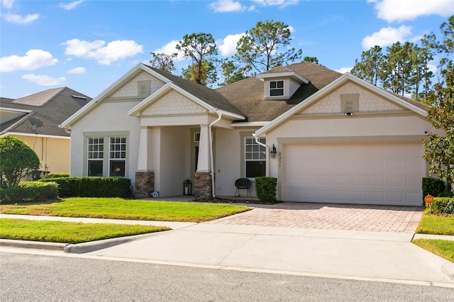 view of front of house featuring a garage and a front lawn