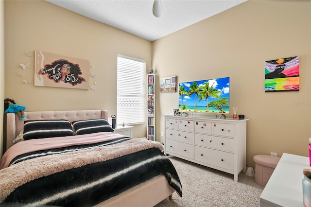 bedroom featuring ceiling fan and light carpet