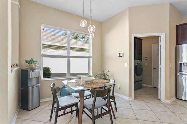 dining room with washer / clothes dryer and light tile patterned floors