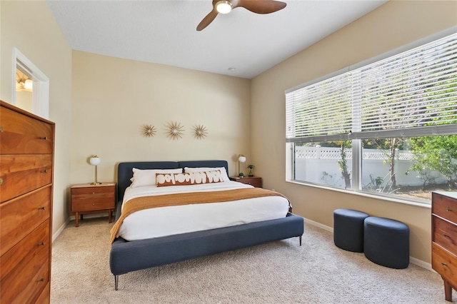 bedroom with light colored carpet and ceiling fan