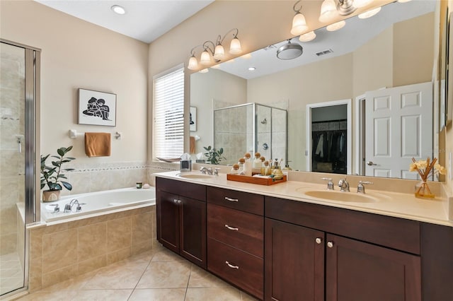 bathroom featuring vanity, tile patterned flooring, and separate shower and tub