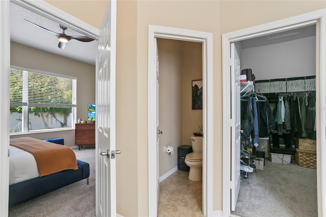 bathroom featuring ceiling fan, tile patterned floors, and toilet