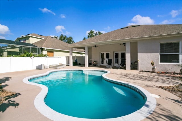 view of swimming pool with ceiling fan and a patio