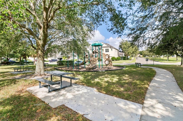 surrounding community with a playground and a lawn