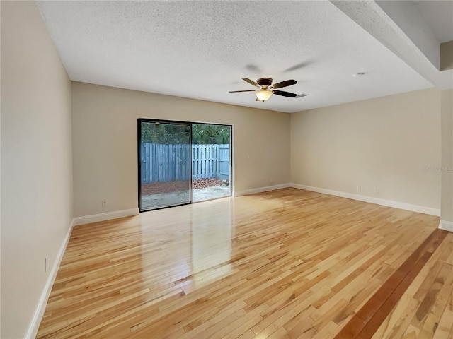 spare room featuring light hardwood / wood-style flooring, a textured ceiling, and ceiling fan