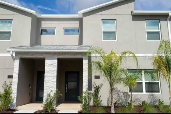 1144 Challenge Dr, Davenport, FL 33896 - view of front of property with a standing seam roof, stucco siding, and metal roof