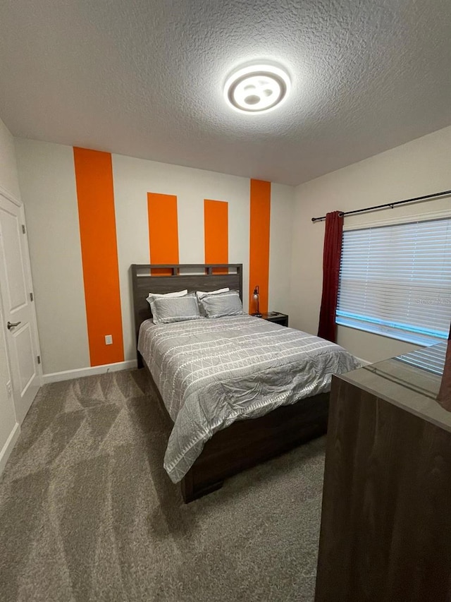 carpeted bedroom with a textured ceiling