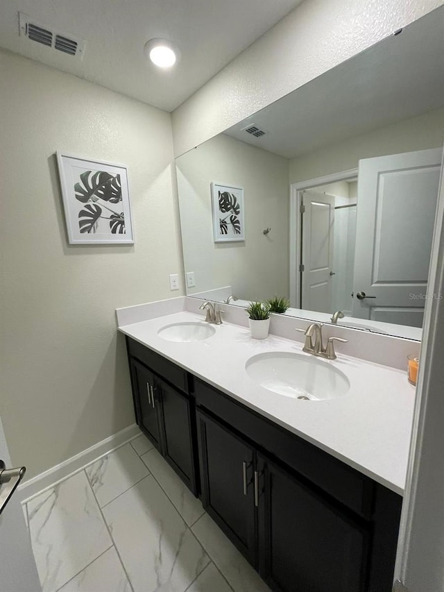 1144 Challenge Dr, Davenport, FL 33896 - full bathroom featuring baseboards, double vanity, and marble look tiles