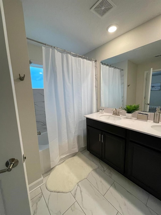 bathroom with vanity and shower / bath combination with curtain