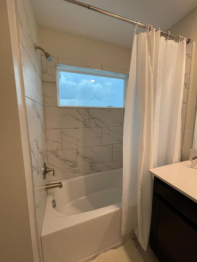 bathroom featuring vanity and shower / tub combo with curtain