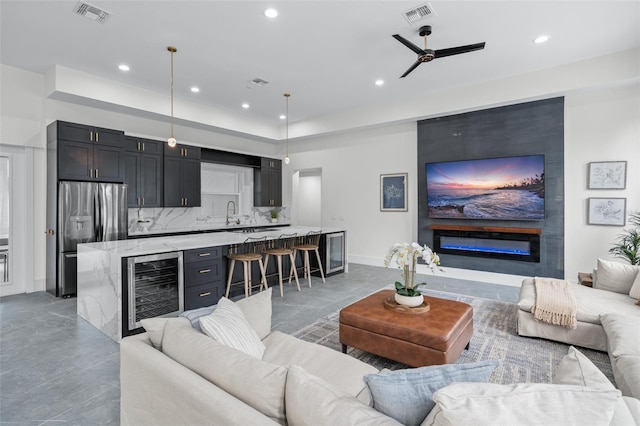 living room featuring ceiling fan and beverage cooler