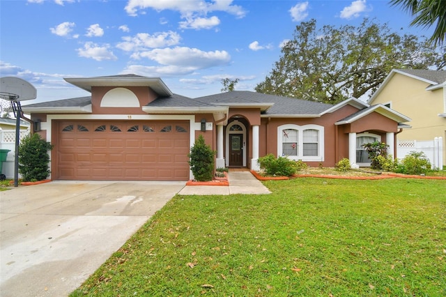 ranch-style house featuring a front lawn and a garage