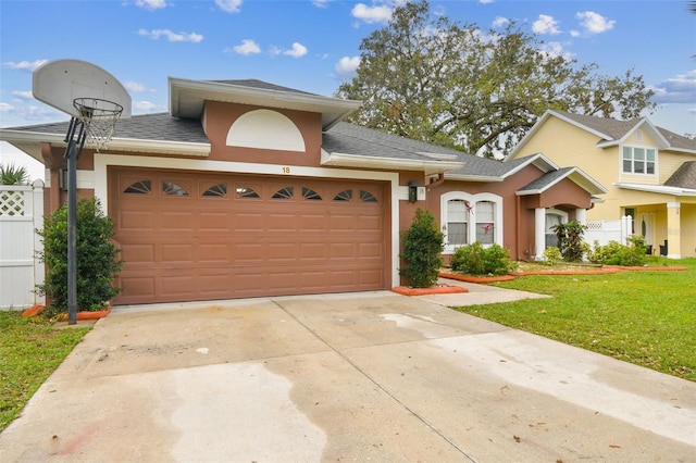 view of front facade featuring a garage and a front lawn