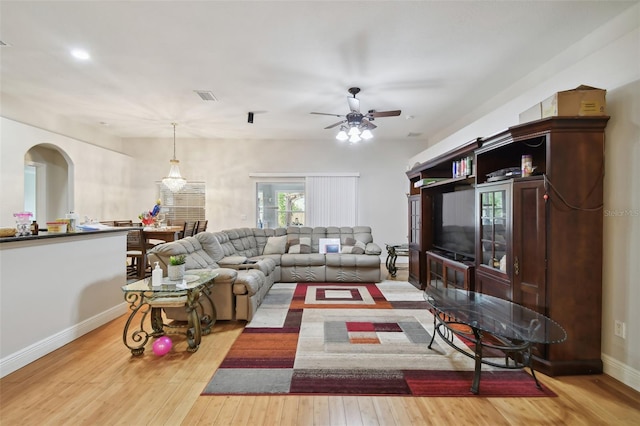 living room featuring light wood-type flooring and ceiling fan