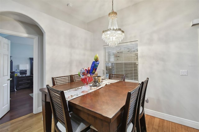 dining room featuring hardwood / wood-style flooring and a notable chandelier