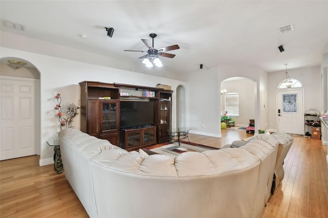 living room with light wood-type flooring and ceiling fan