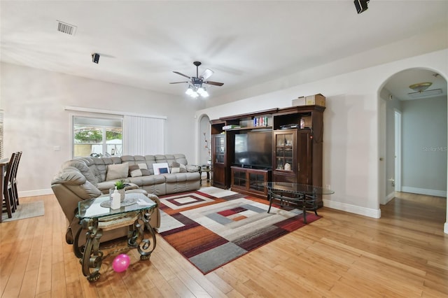 living room featuring ceiling fan and wood-type flooring