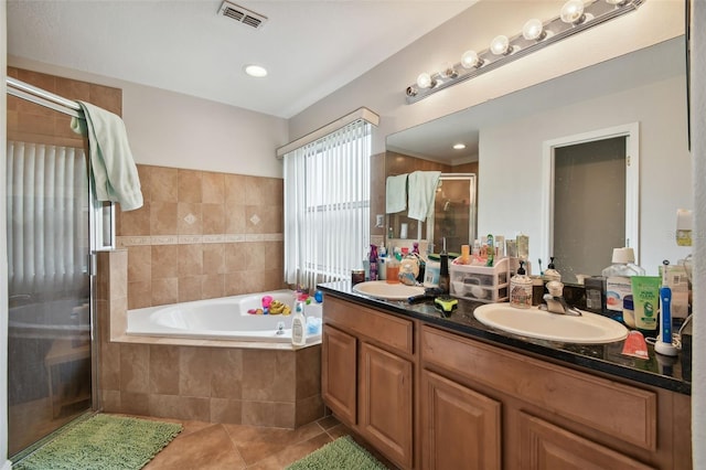 bathroom with vanity, plus walk in shower, and tile patterned flooring