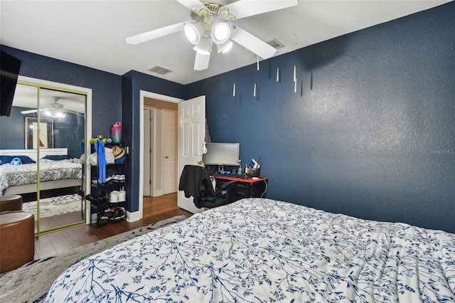 bedroom with hardwood / wood-style floors, ceiling fan, and a closet