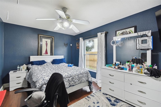 bedroom with hardwood / wood-style flooring and ceiling fan