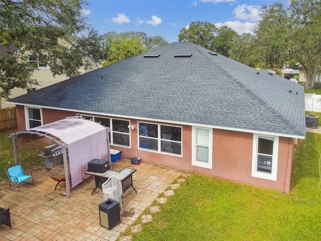 back of house with a patio and a yard