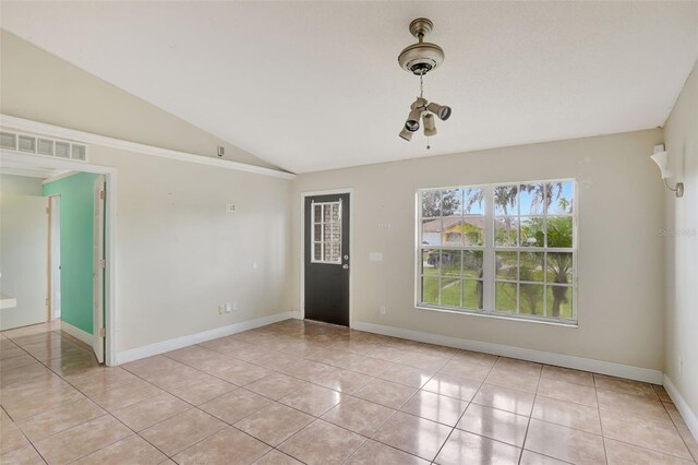 1053 E Hancock Dr, Deltona, FL 32725 - unfurnished room with light tile patterned flooring and lofted ceiling