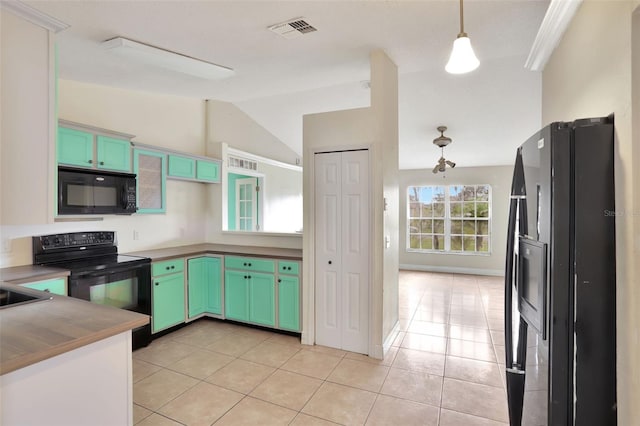 1053 E Hancock Dr, Deltona, FL 32725 - kitchen with black appliances, lofted ceiling, light tile patterned flooring, and pendant lighting