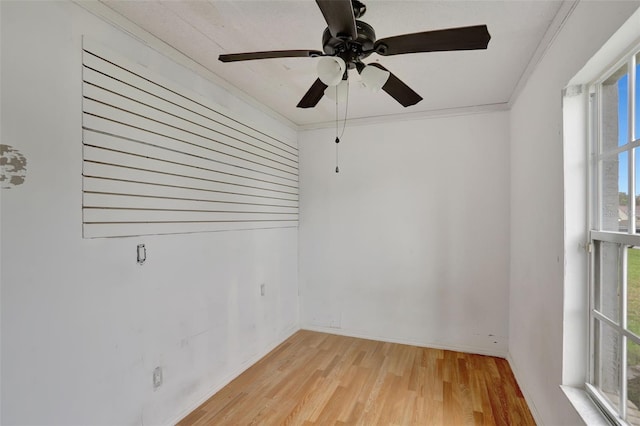 1053 E Hancock Dr, Deltona, FL 32725 - empty room featuring plenty of natural light, light wood finished floors, ornamental molding, and a ceiling fan