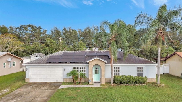 1053 E Hancock Dr, Deltona, FL 32725 - ranch-style home featuring brick siding, an attached garage, roof mounted solar panels, and driveway