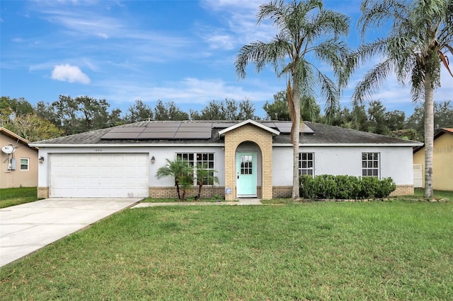 1053 E Hancock Dr, Deltona, FL 32725 - ranch-style home featuring brick siding, a garage, stucco siding, and a front yard