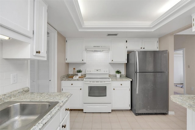 kitchen featuring white electric range oven, white cabinetry, ornamental molding, a raised ceiling, and stainless steel refrigerator