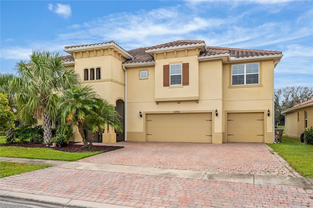 mediterranean / spanish-style home with a garage