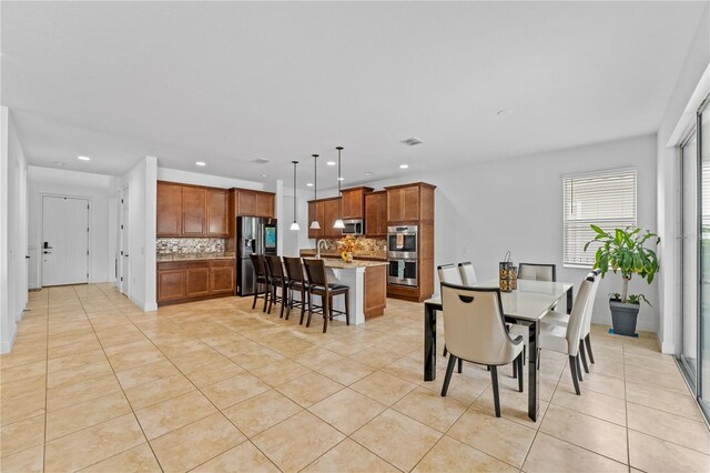 dining space featuring light tile patterned floors