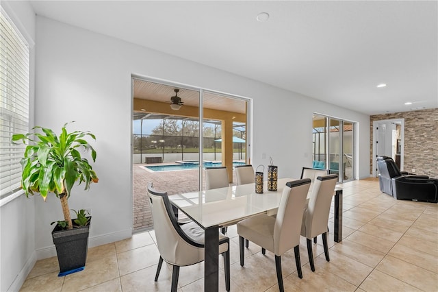 dining room with ceiling fan and light tile patterned flooring