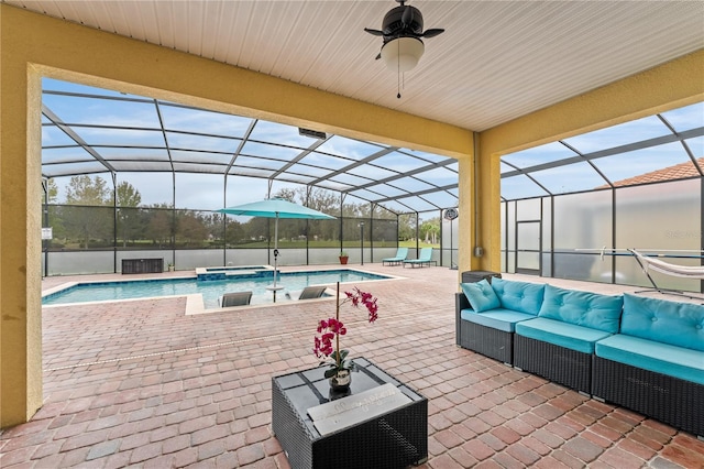 view of swimming pool with ceiling fan, a patio area, a lanai, and an outdoor living space