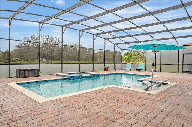 view of swimming pool featuring glass enclosure, a patio area, and an in ground hot tub