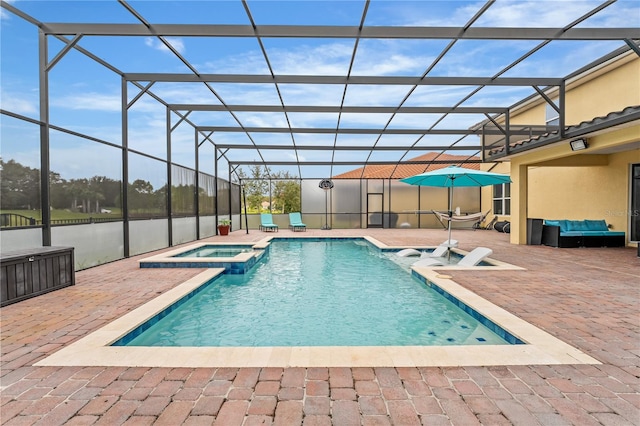 view of swimming pool with a lanai, an in ground hot tub, and a patio area