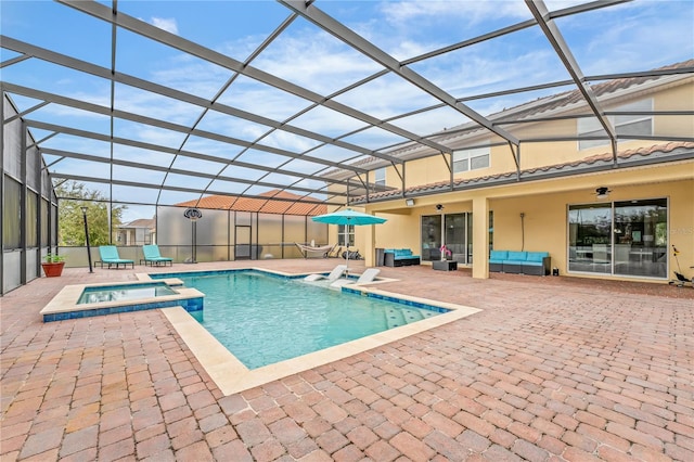 view of swimming pool with a lanai, a patio, and an in ground hot tub