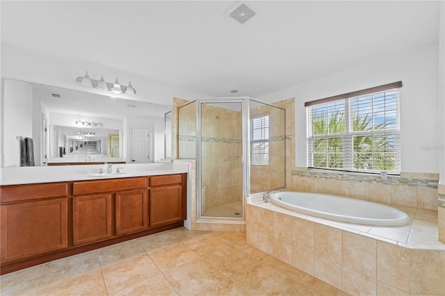 bathroom featuring vanity, tile patterned floors, and plus walk in shower