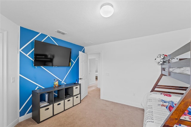 recreation room featuring a textured ceiling and carpet flooring