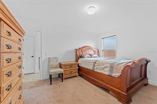 bedroom featuring light colored carpet