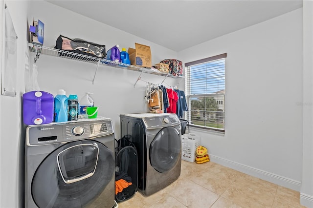 laundry area with separate washer and dryer and light tile patterned flooring